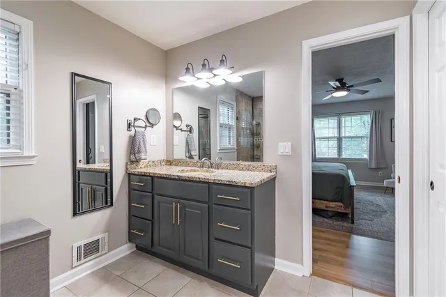 a bathroom with a double vanity sink and a mirror