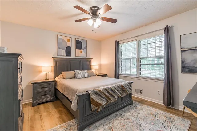a bedroom with a large bed and a chandelier