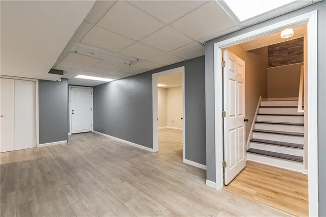a view of a hallway with wooden floor and entryway