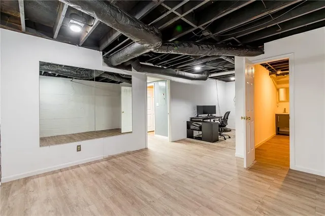 a view of an empty room with wooden floor