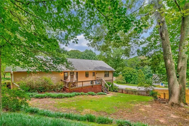 a aerial view of a house with swimming pool next to a big yard