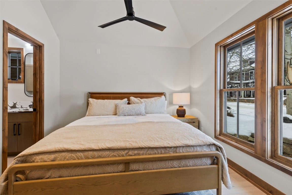 203 North Ridge Street, Unit B Breckenridge, CO 80424 - Photo 19 of 49 Bedroom with vaulted ceiling, ensuite bathroom, a ceiling fan, and wood finished floors