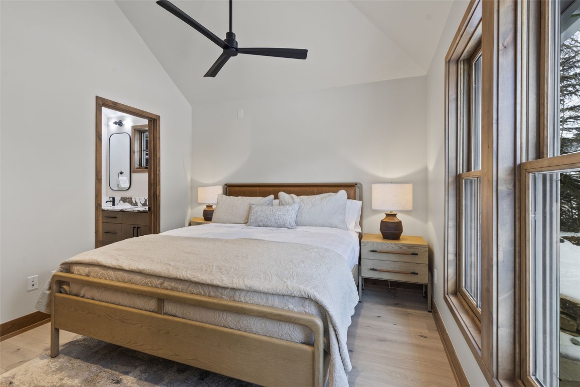 203 North Ridge Street, Unit B Breckenridge, CO 80424 - Photo 20 of 49 Bedroom with light wood-style floors, ceiling fan, ensuite bath, and high vaulted ceiling