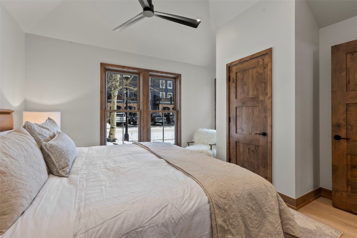 203 North Ridge Street, Unit B Breckenridge, CO 80424 - Photo 21 of 49 Bedroom featuring ceiling fan, vaulted ceiling, and wood finished floors