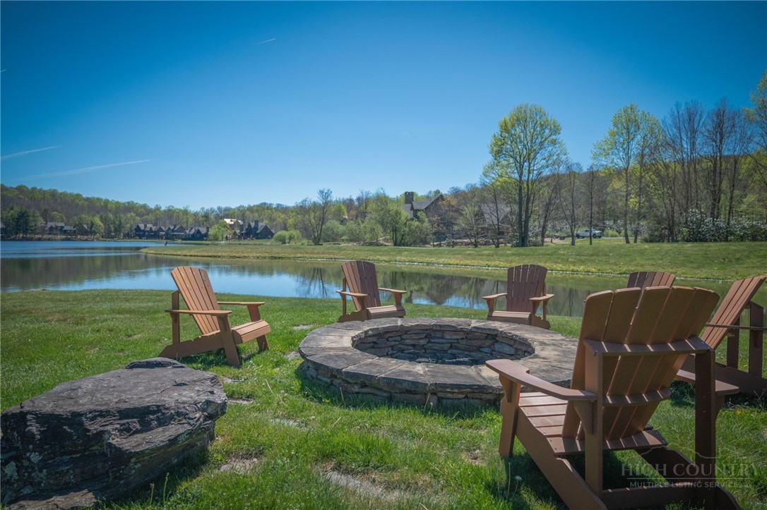 Owls Brow Ridge Blowing Rock, NC 28605 - Photo 1 of 32 a view of a lake with a yard and outdoor seating