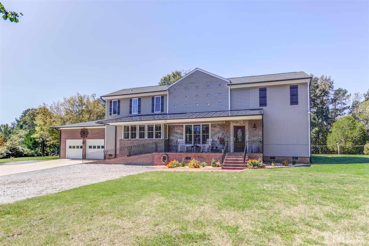 9554 Valley Road Middlesex, NC 27557 - Photo 2 of 30 a view of a house with a yard patio and a garden