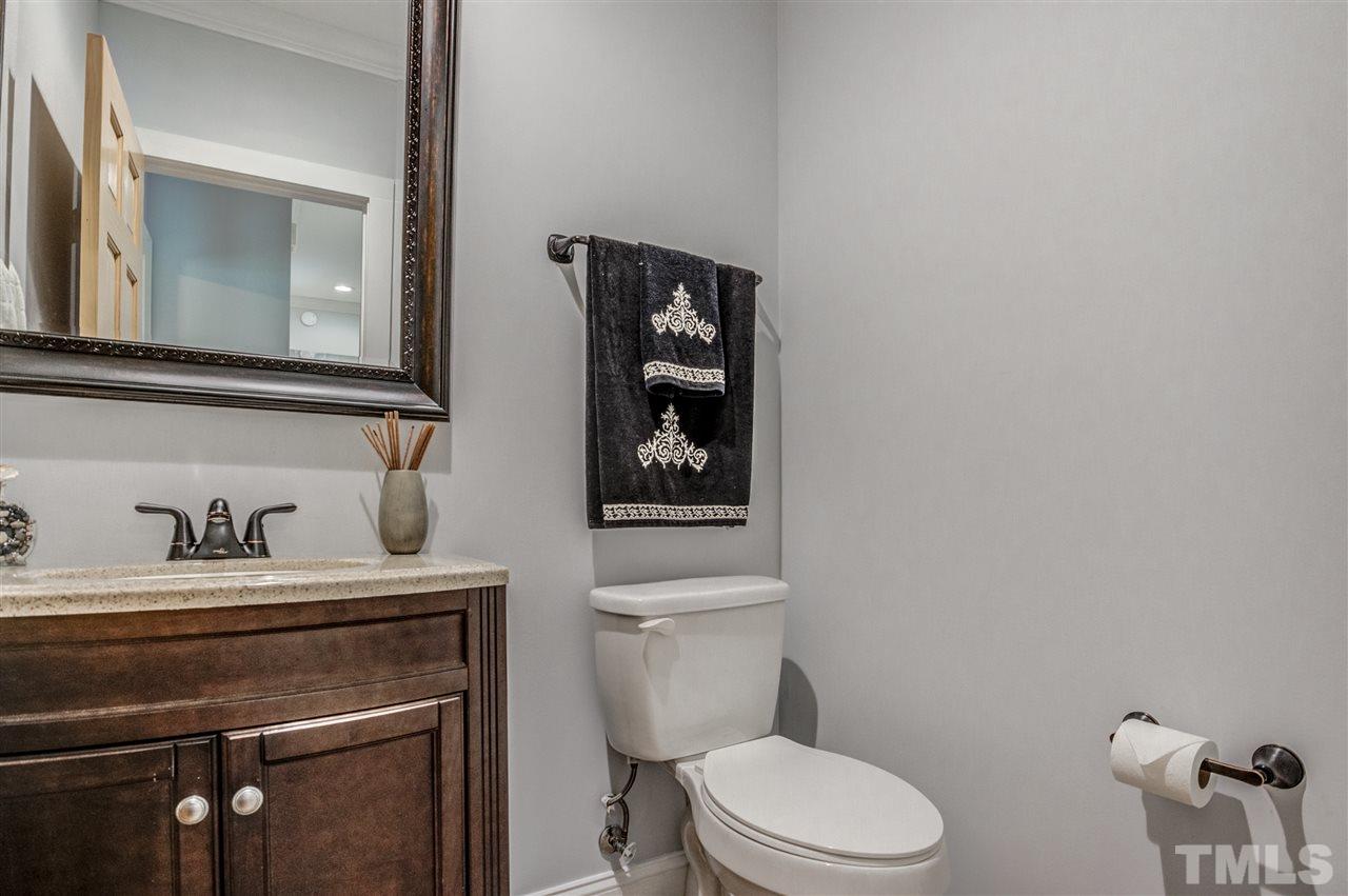 9554 Valley Road Middlesex, NC 27557 - Photo 14 of 30 a bathroom with a toilet a sink and mirror