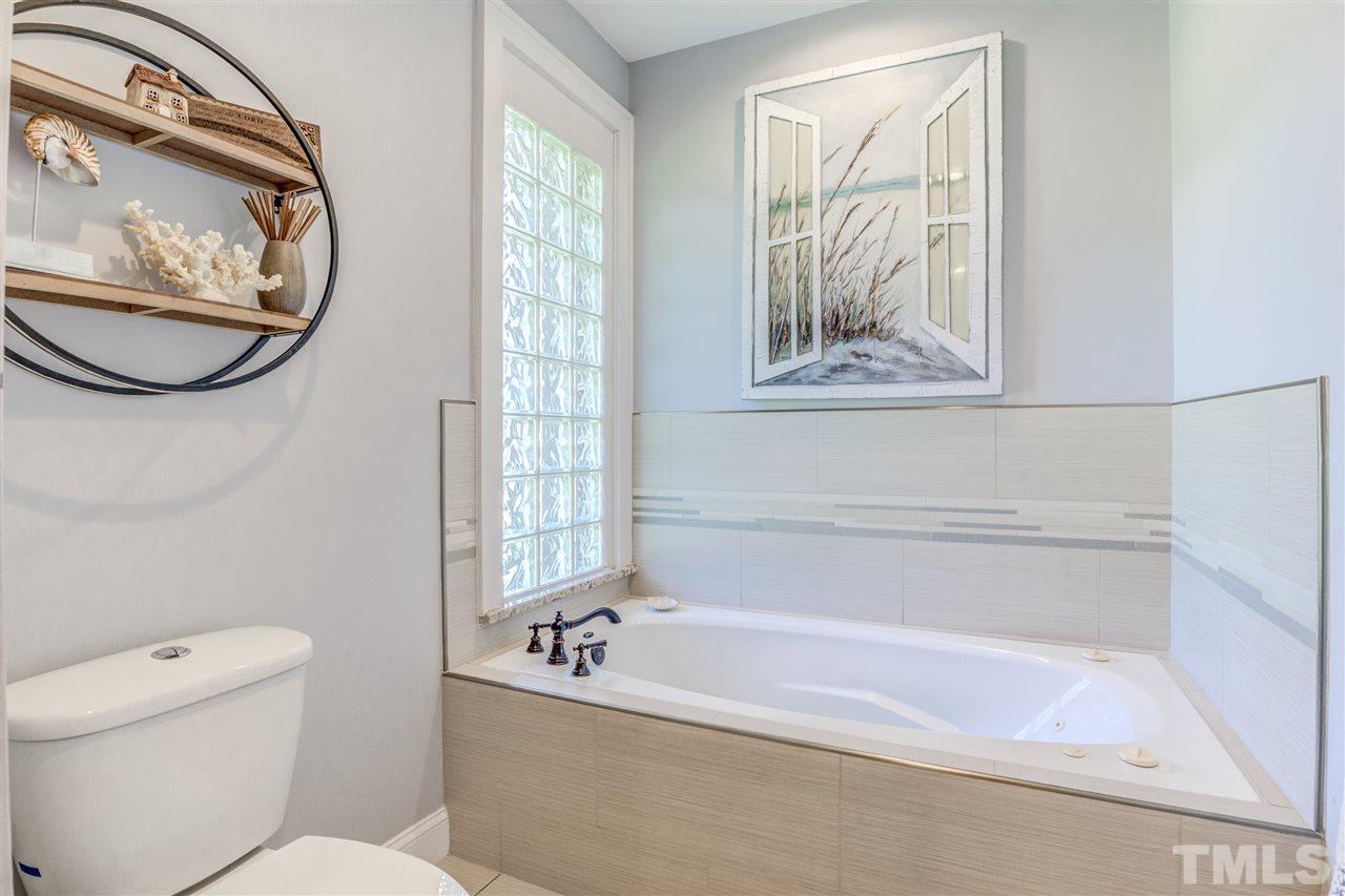 9554 Valley Road Middlesex, NC 27557 - Photo 18 of 30 a bath room with a toilet and a tub