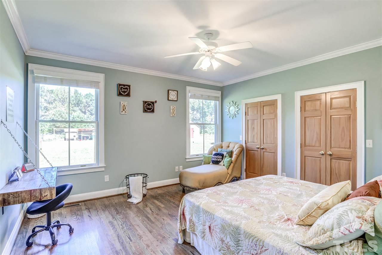 9554 Valley Road Middlesex, NC 27557 - Photo 19 of 30 a bedroom with a bed and wooden floor