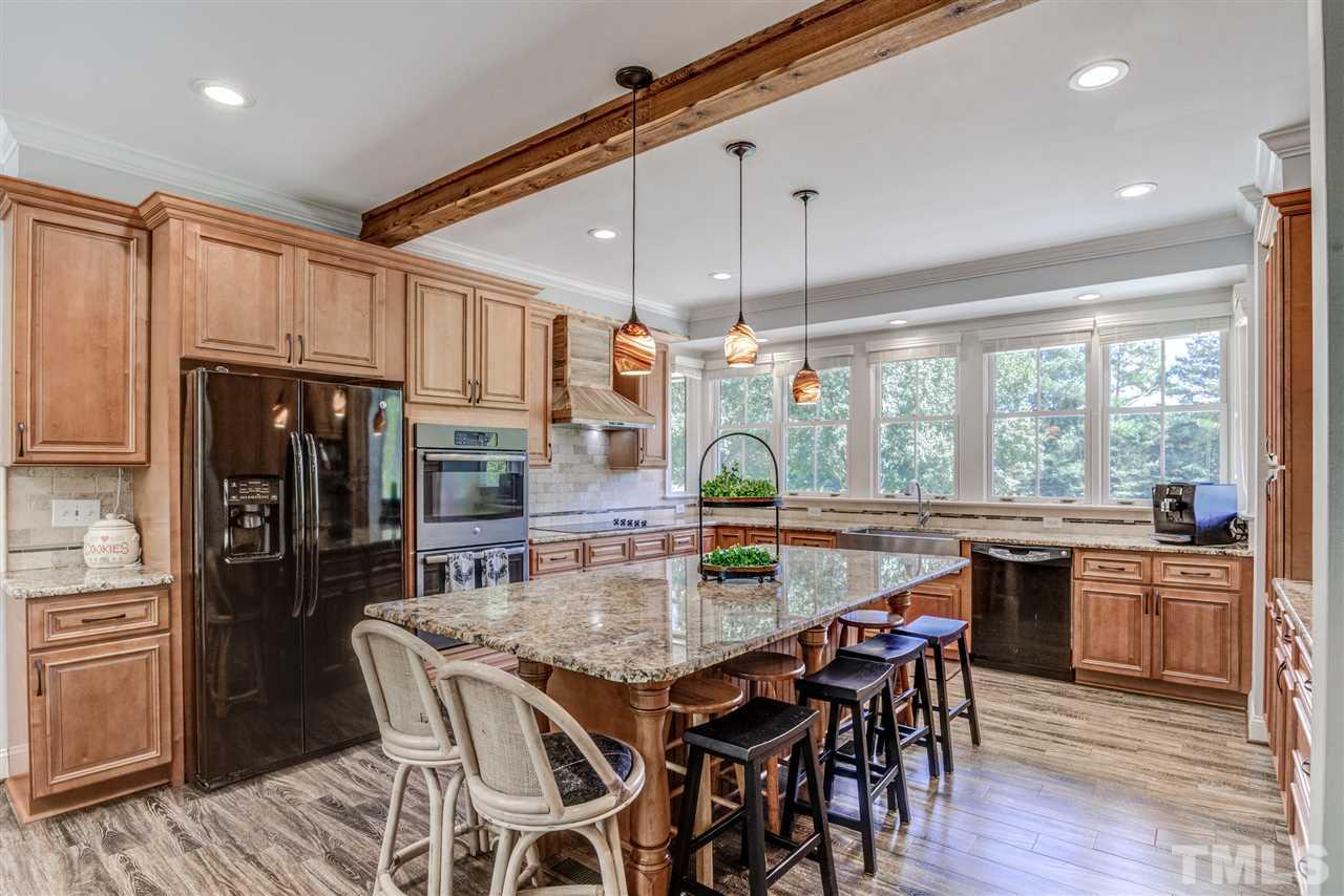 9554 Valley Road Middlesex, NC 27557 - Photo 8 of 30 a kitchen with stainless steel appliances granite countertop a kitchen island hardwood floor and a sink