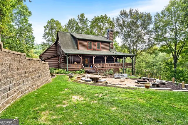 a front view of a house with garden and sitting area