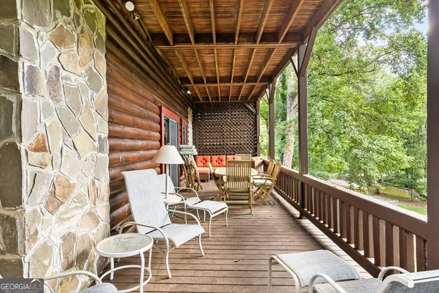a front view of a house with a yard and an trees