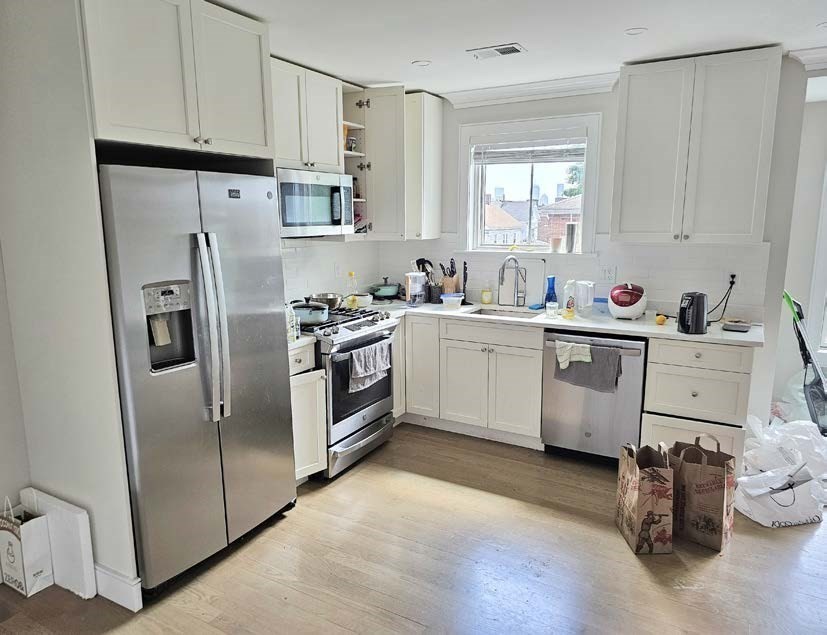13 Greylock Road Boston, MA 02134 - Photo 11 of 17 a kitchen with stainless steel appliances a sink a stove a refrigerator cabinets and a window