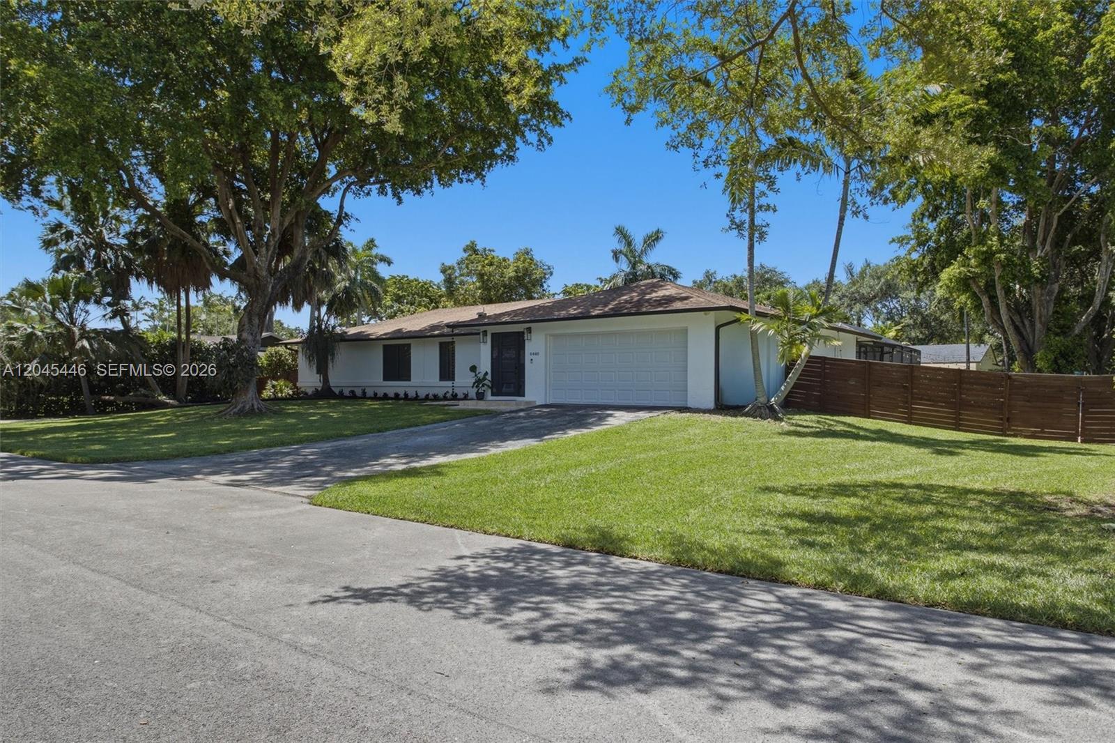 8440 Southwest 180th Street Palmetto Bay, FL 33157 - Photo 42 of 54 a front view of a house with a garden