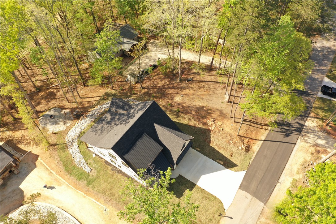 407 Blue Ridge Court Westminster, SC 29693 - Photo 39 of 48 Perched among verdant trees, this home features a pristine driveway and a well-maintained roof.