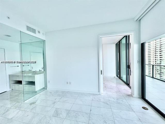 480 Northeast 31st Street, Unit 902 Miami, FL 33137 - Photo 14 of 33 a view of a hallway to kitchen and a sink