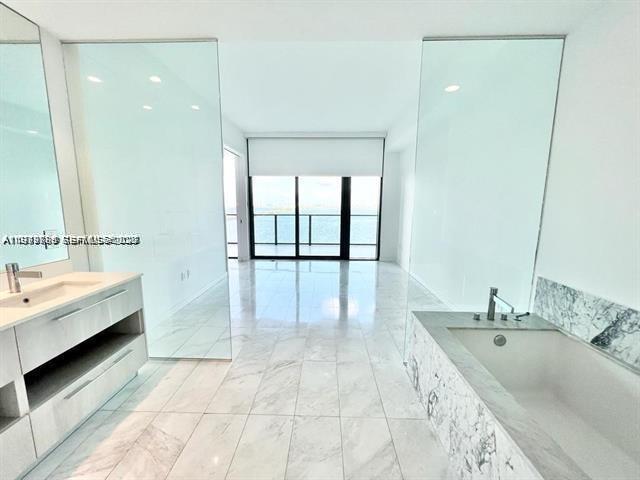 480 Northeast 31st Street, Unit 902 Miami, FL 33137 - Photo 15 of 33 a bathroom with a tub sink and mirror