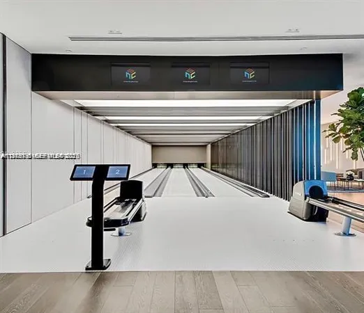 a living room with furniture pool table and a ceiling fan