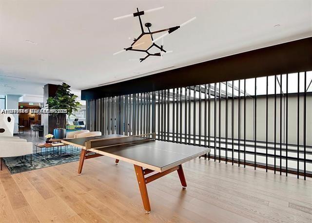 480 Northeast 31st Street, Unit 902 Miami, FL 33137 - Photo 24 of 33 a living room with furniture pool table and a ceiling fan