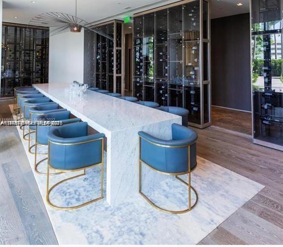 480 Northeast 31st Street, Unit 902 Miami, FL 33137 - Photo 29 of 33 a dining room with furniture and wooden floor