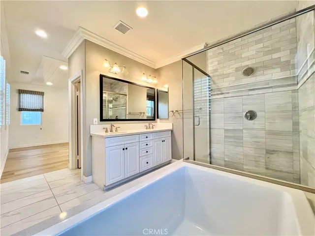 a spacious bathroom with a granite countertop sink mirror and shower