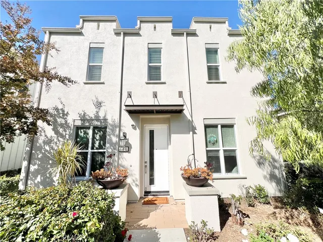 a view of a patio with table and chairs and potted plants