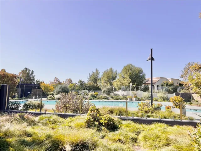 a view of backyard with outdoor seating and trees