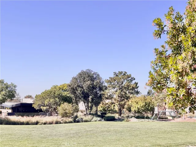 a view of a building with cars parked