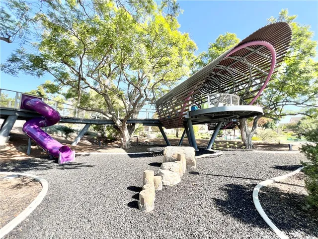 a view of a yard with plants and trees
