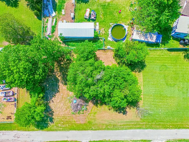 a view of a house with a backyard and a fountain