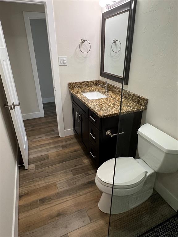 511 West Retta Esplanade Punta Gorda, FL 33950 - Photo 15 of 19 a bathroom with a granite countertop toilet sink and mirror