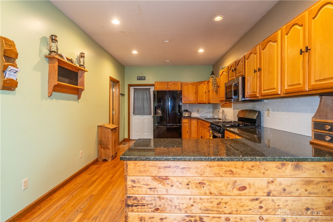 10584 New Biddinger Road Harrison, OH 45030 - Photo 21 of 61 This spacious kitchen offers ample countertop space, recessed lighting, and rich hardwood flooring.