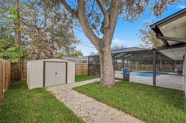 a view of a house with a yard and tree s