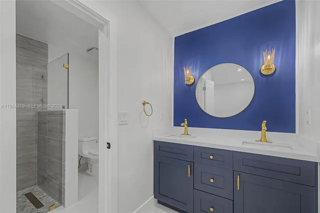 a bathroom with a double vanity sink and a mirror