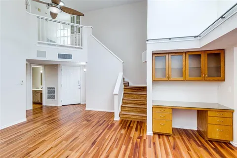 a view of a room with wooden floor and stairs