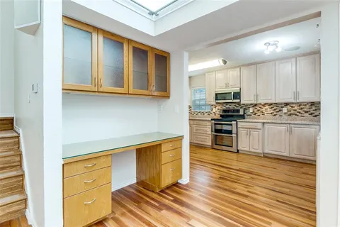 a kitchen with stainless steel appliances a stove a sink and cabinets