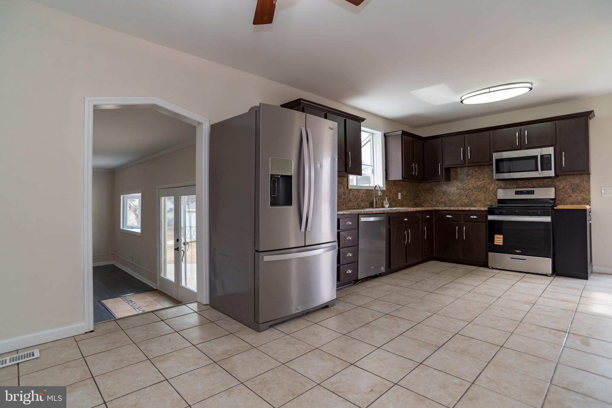 2427 Buttonwood Lane Millville, NJ 08332 - Photo 11 of 58 a kitchen with stainless steel appliances granite countertop a refrigerator and a sink