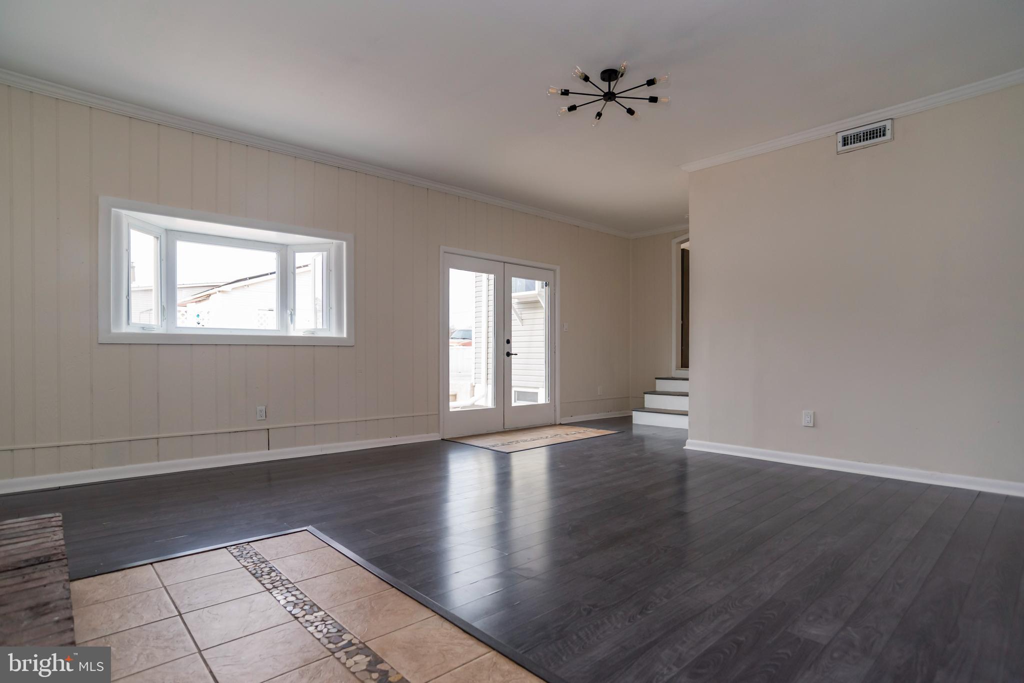 2427 Buttonwood Lane Millville, NJ 08332 - Photo 17 of 58 a view of an empty room with window and wooden floor