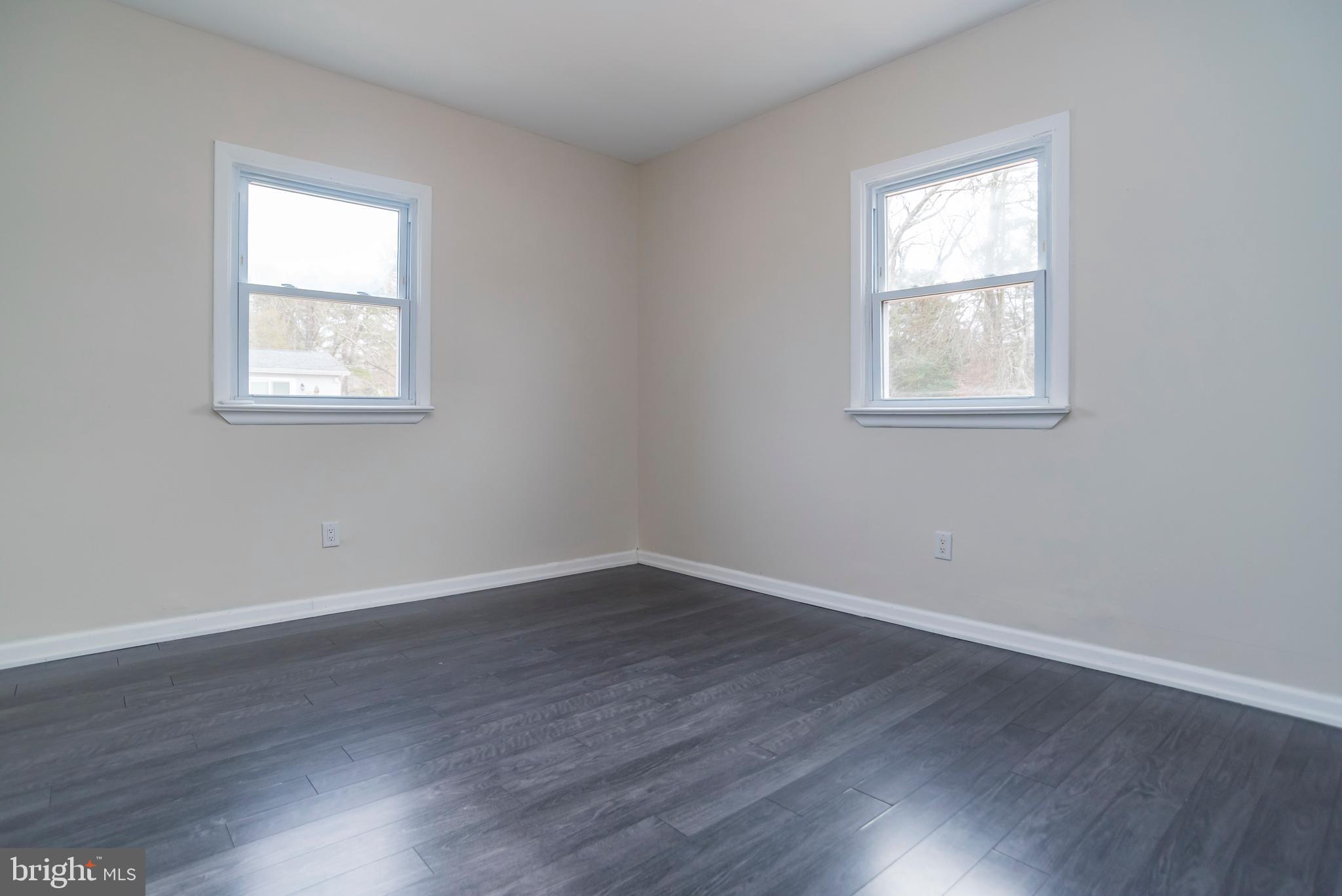 2427 Buttonwood Lane Millville, NJ 08332 - Photo 18 of 58 a view of an empty room with wooden floor and a window