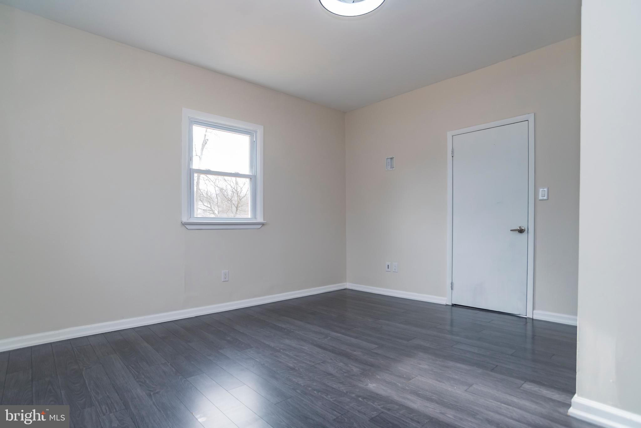 2427 Buttonwood Lane Millville, NJ 08332 - Photo 19 of 58 an empty room with wooden floor and windows