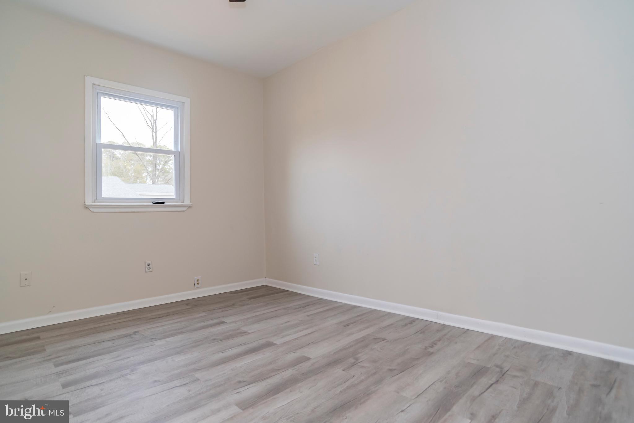 2427 Buttonwood Lane Millville, NJ 08332 - Photo 23 of 58 wooden floor in an empty room with a window