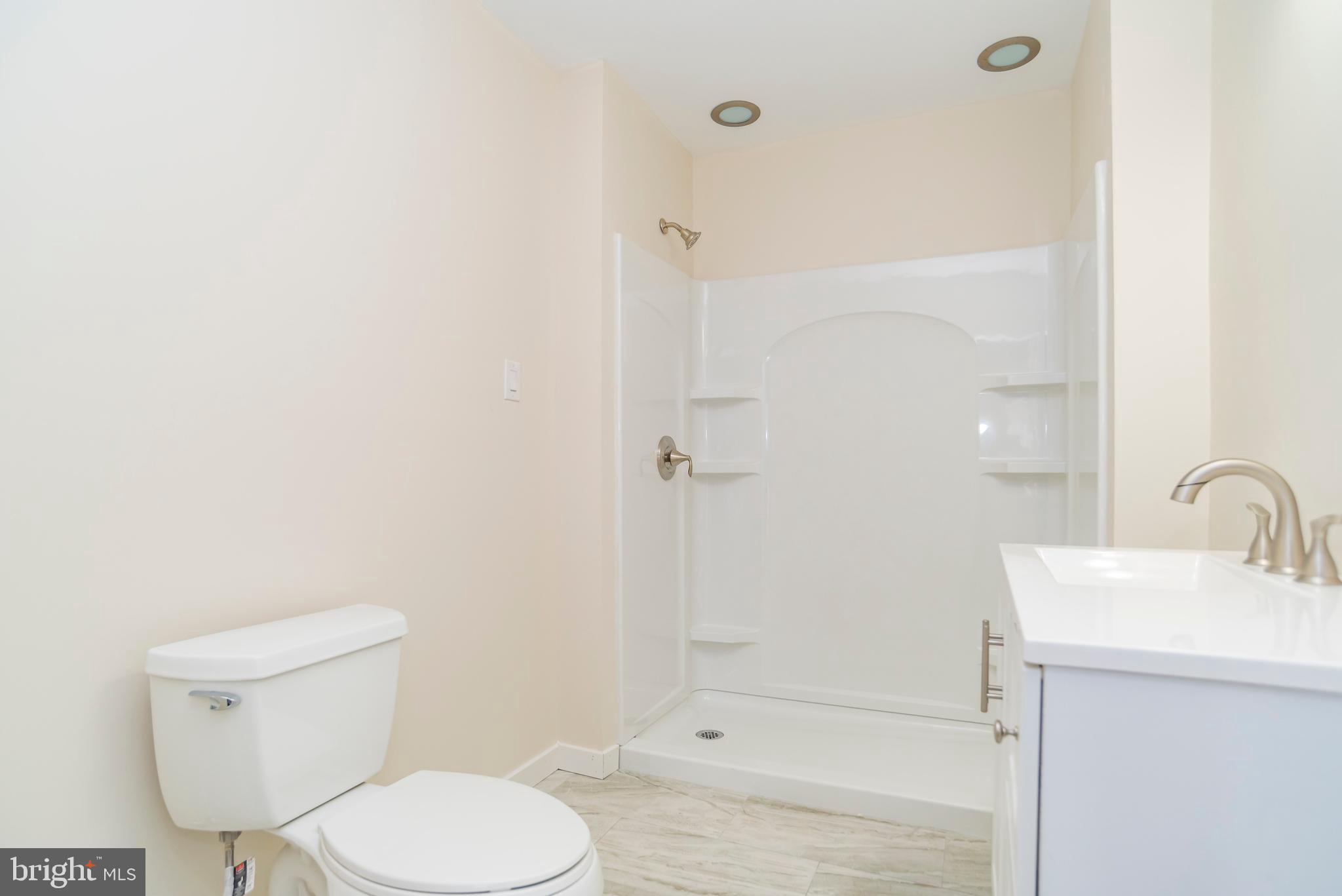2427 Buttonwood Lane Millville, NJ 08332 - Photo 26 of 58 a bathroom with a toilet a sink and shower