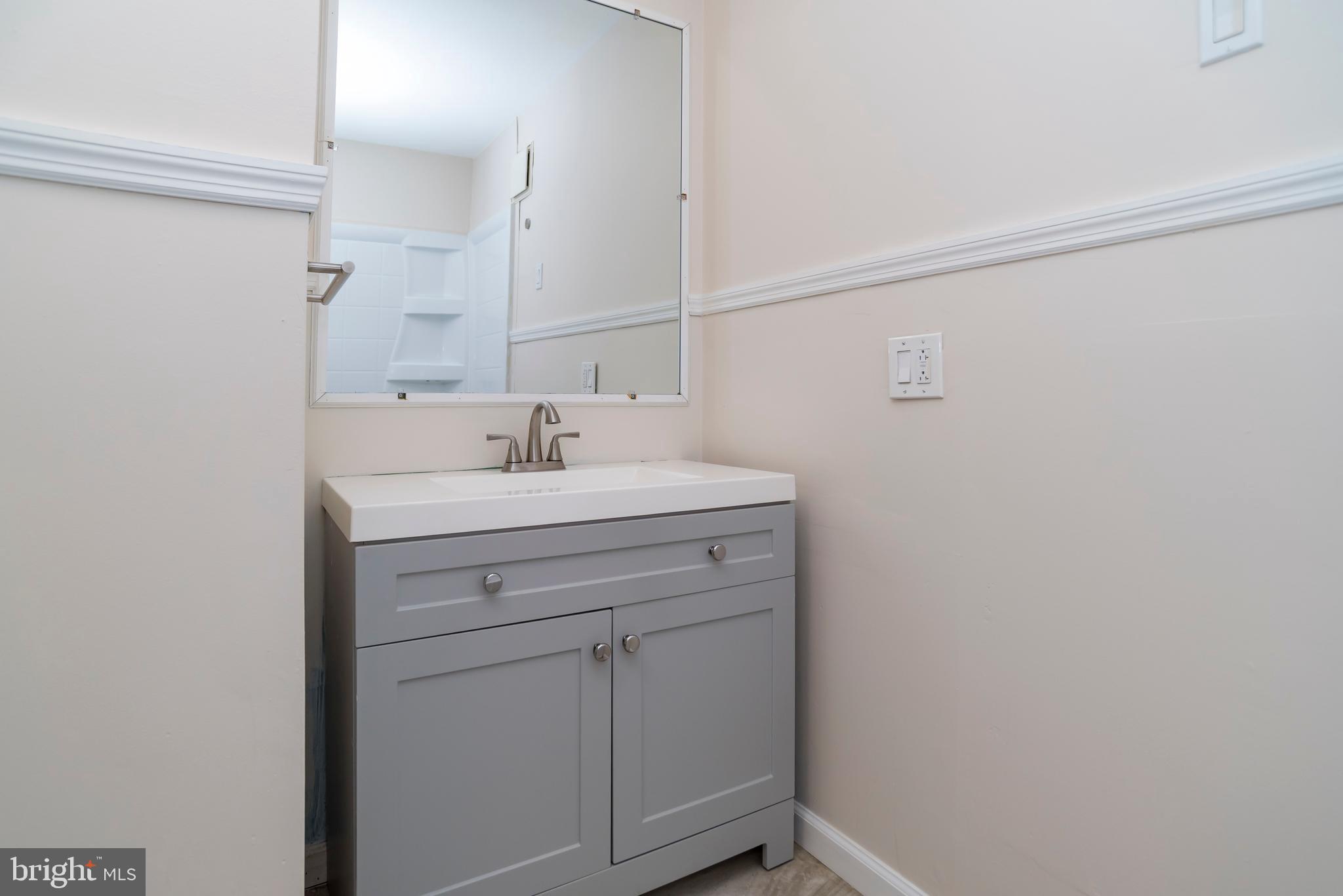 2427 Buttonwood Lane Millville, NJ 08332 - Photo 29 of 58 a bathroom with a sink and a mirror