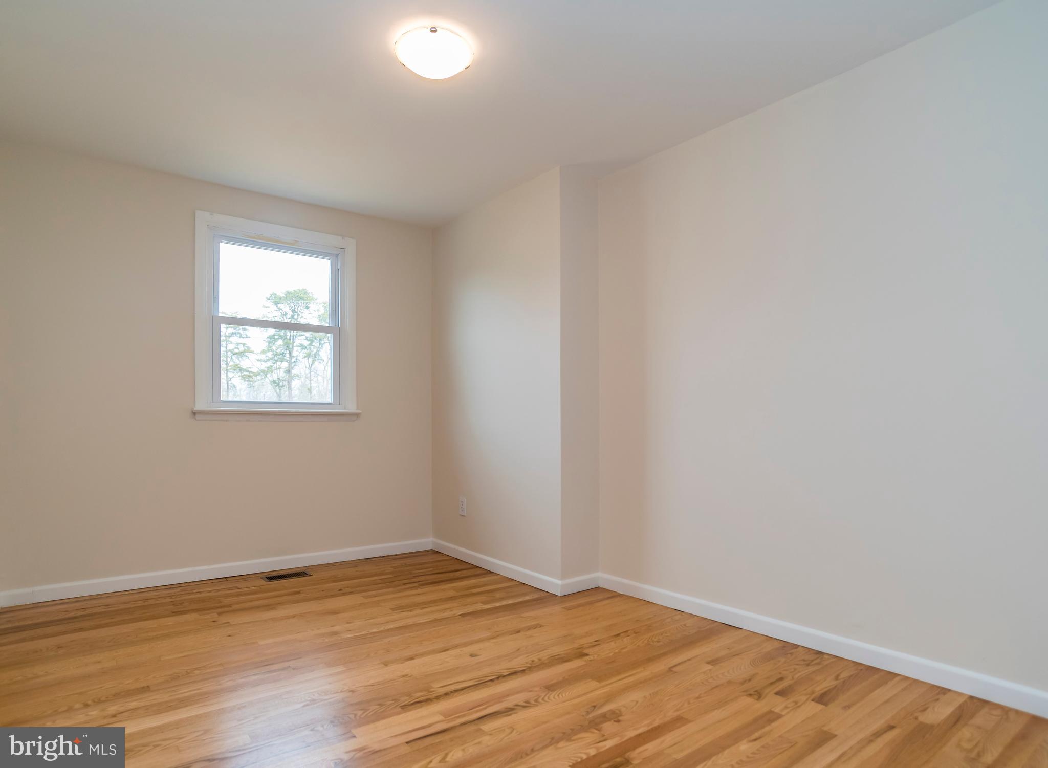 2427 Buttonwood Lane Millville, NJ 08332 - Photo 30 of 58 a view of empty room with wooden floor and fan
