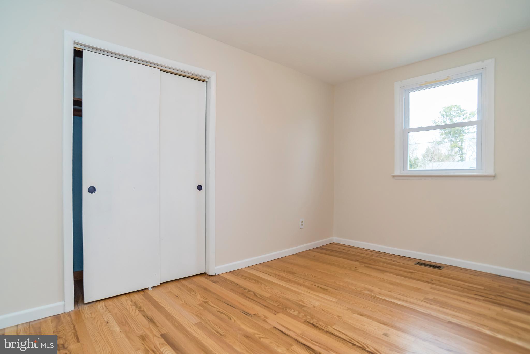 2427 Buttonwood Lane Millville, NJ 08332 - Photo 31 of 58 an empty room with wooden floor and windows