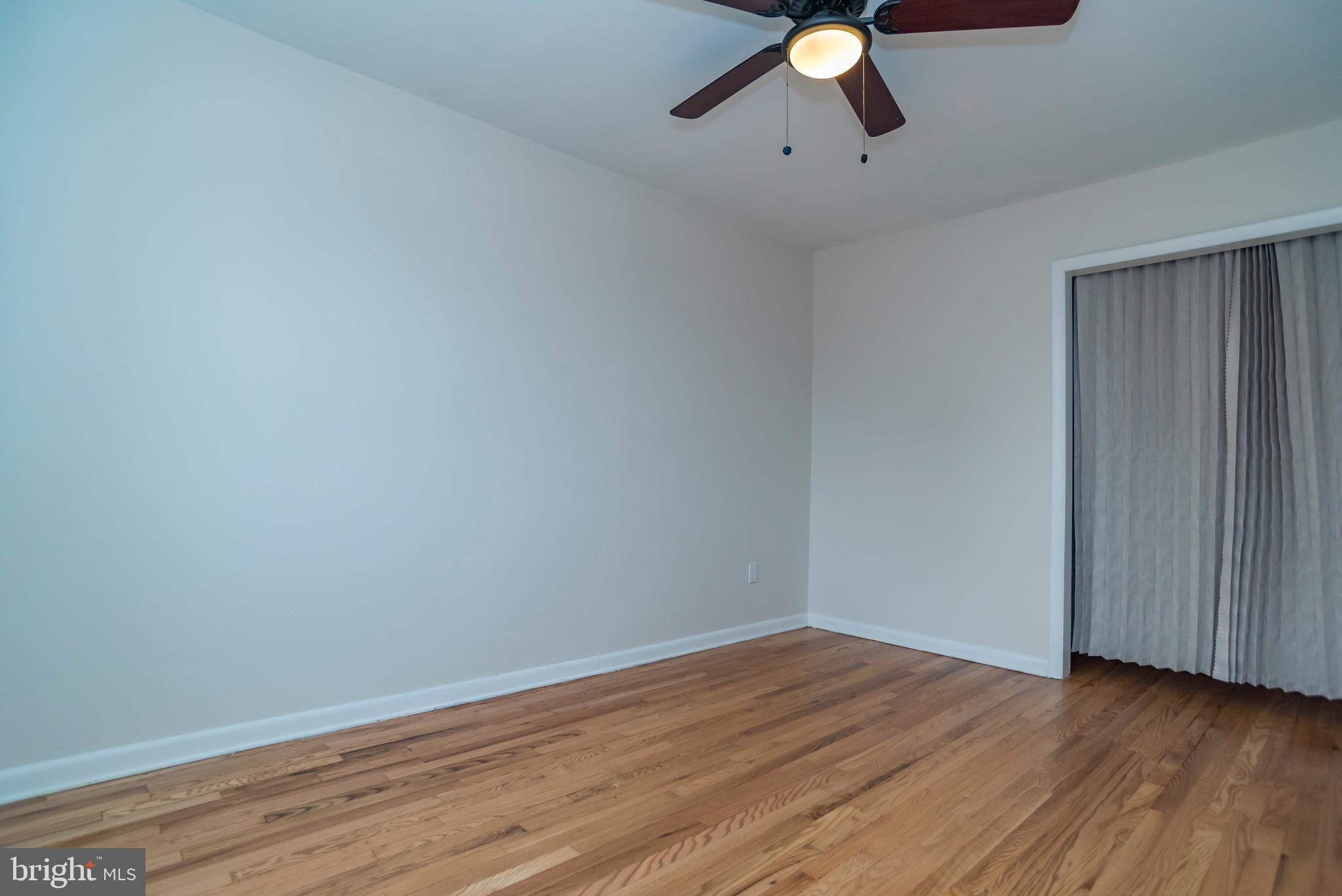 2427 Buttonwood Lane Millville, NJ 08332 - Photo 37 of 58 a view of an empty room with wooden floor and fan