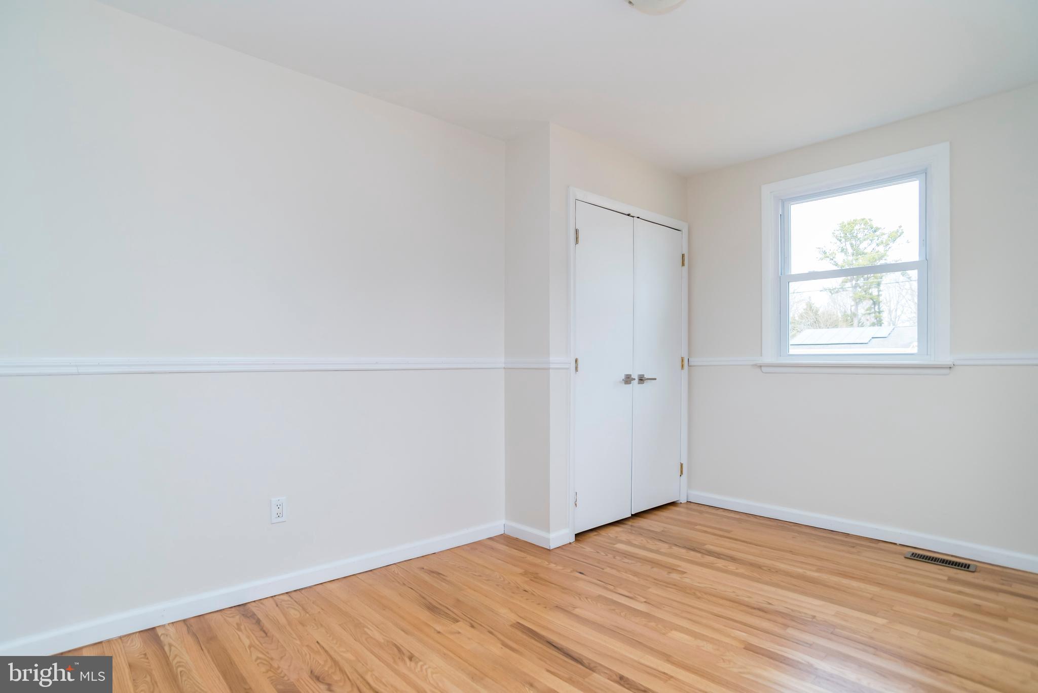 2427 Buttonwood Lane Millville, NJ 08332 - Photo 40 of 58 a view of an empty room with wooden floor and a window