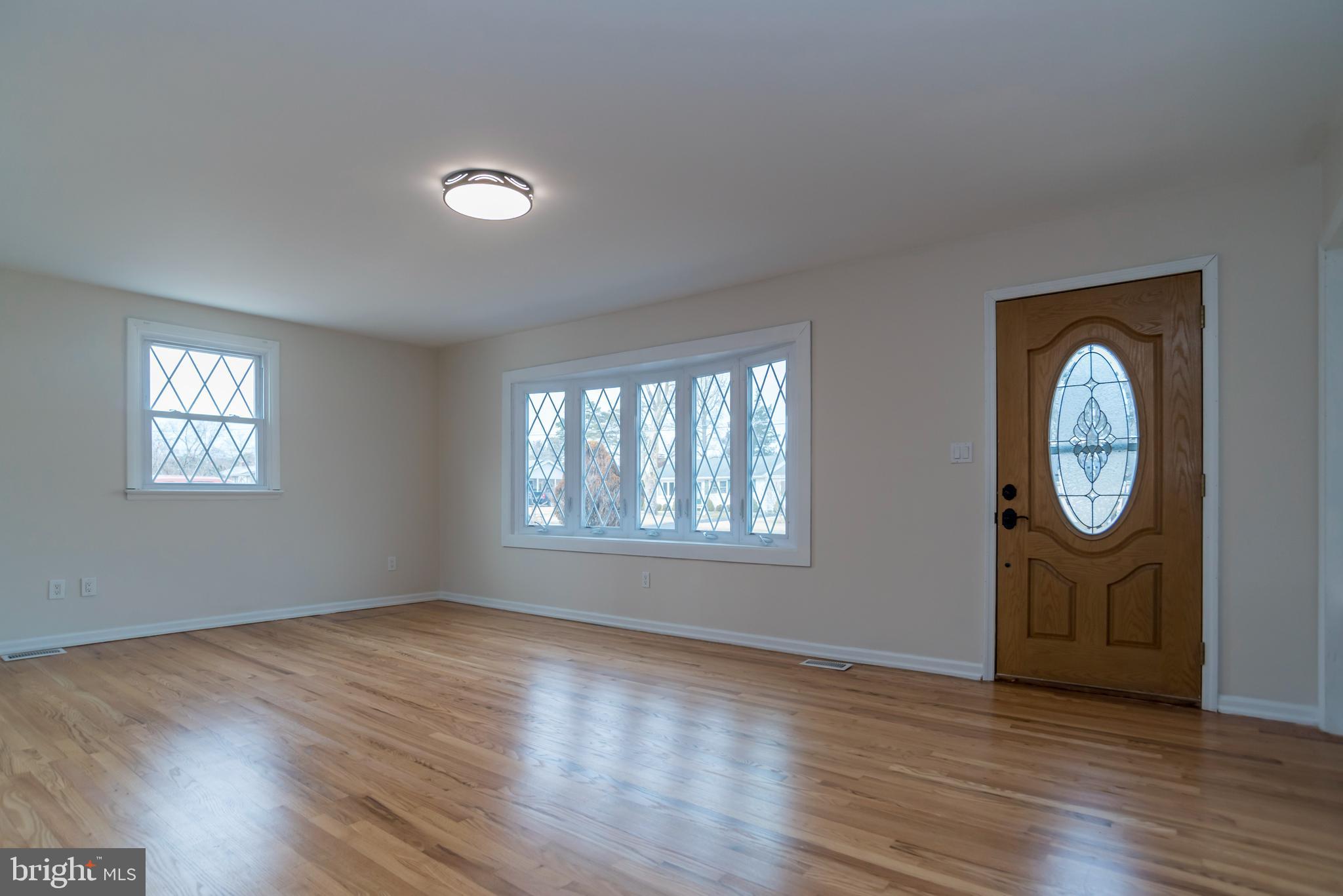 2427 Buttonwood Lane Millville, NJ 08332 - Photo 6 of 58 an empty room with wooden floor and window
