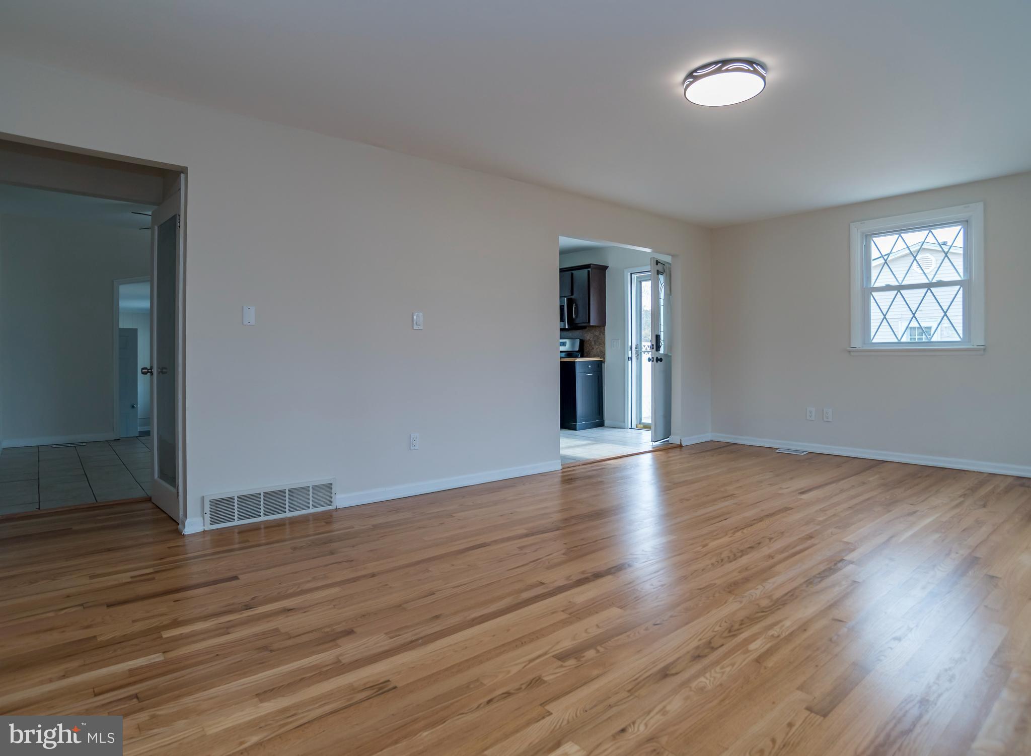 2427 Buttonwood Lane Millville, NJ 08332 - Photo 7 of 58 an empty room with wooden floor and windows