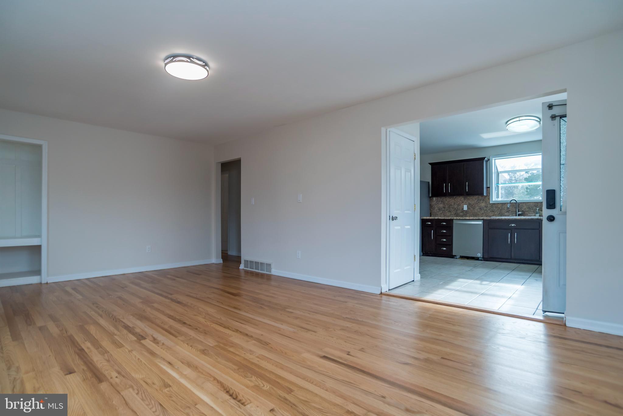 2427 Buttonwood Lane Millville, NJ 08332 - Photo 8 of 58 an empty room with wooden floor and windows